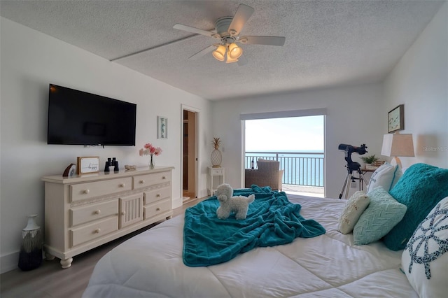 1270 Gulf Blvd Unit 1901, Clearwater Beach, FL 33767 - bedroom featuring a textured ceiling, access to exterior, ceiling fan, and wood finished floors