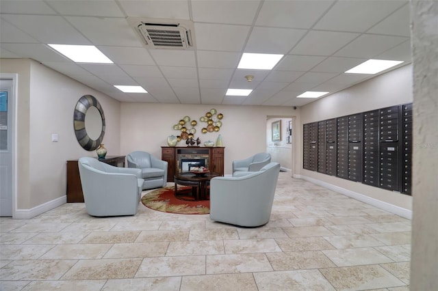 1270 Gulf Blvd Unit 1901, Clearwater Beach, FL 33767 - living area featuring baseboards, a paneled ceiling, and mail area