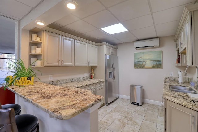 1270 Gulf Blvd Unit 1901, Clearwater Beach, FL 33767 - kitchen with stainless steel fridge with ice dispenser, a sink, open shelves, a wall mounted AC, and a paneled ceiling