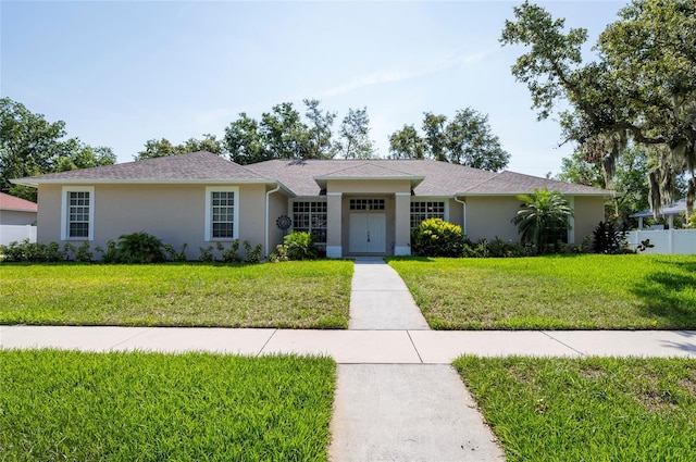 9908 Alafia River Ln, Gibsonton, FL 33534 - ranch-style home with stucco siding and a front lawn