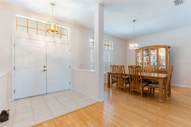 9908 Alafia River Ln, Gibsonton, FL 33534 - entrance foyer featuring a chandelier, baseboards, and light wood-type flooring