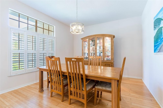 9908 Alafia River Ln, Gibsonton, FL 33534 - dining area featuring a chandelier, light wood-style flooring, and baseboards