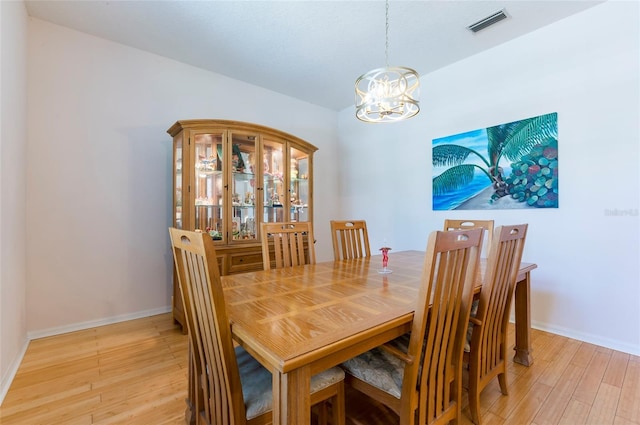 9908 Alafia River Ln, Gibsonton, FL 33534 - dining area featuring light wood finished floors, a chandelier, and baseboards