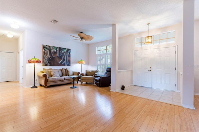 9908 Alafia River Ln, Gibsonton, FL 33534 - foyer entrance with light wood finished floors, a ceiling fan, and baseboards