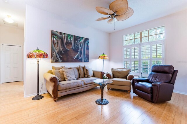 9908 Alafia River Ln, Gibsonton, FL 33534 - living room featuring a ceiling fan, light wood-style flooring, and baseboards