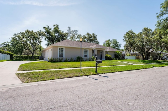 9908 Alafia River Ln, Gibsonton, FL 33534 - single story home featuring driveway, a front lawn, an attached garage, central AC, and stucco siding