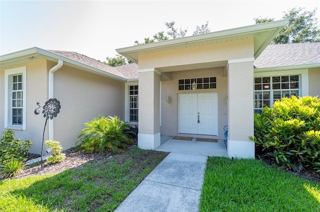 9908 Alafia River Ln, Gibsonton, FL 33534 - doorway to property with roof with shingles and stucco siding