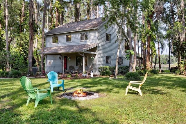 22004 Dupree Dr, Land O Lakes, FL 34639 - back of property featuring a fire pit, a lawn, and central AC unit