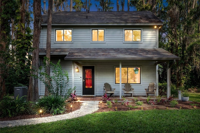 22004 Dupree Dr, Land O Lakes, FL 34639 - view of front of house with a porch, a front lawn, and roof with shingles