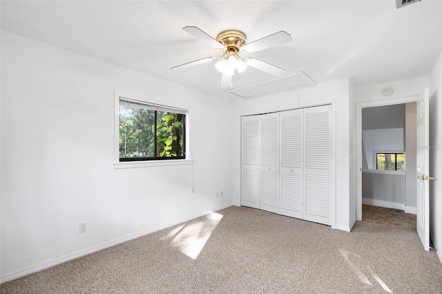 22004 Dupree Dr, Land O Lakes, FL 34639 - unfurnished bedroom with attic access, multiple windows, and carpet flooring