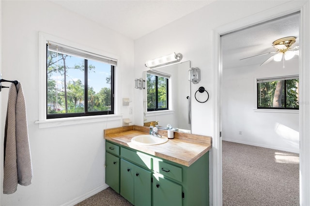 22004 Dupree Dr, Land O Lakes, FL 34639 - bathroom featuring vanity, baseboards, and a ceiling fan