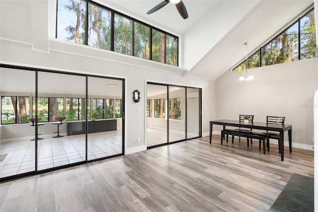 22004 Dupree Dr, Land O Lakes, FL 34639 - living area with high vaulted ceiling, ceiling fan, plenty of natural light, and wood finished floors