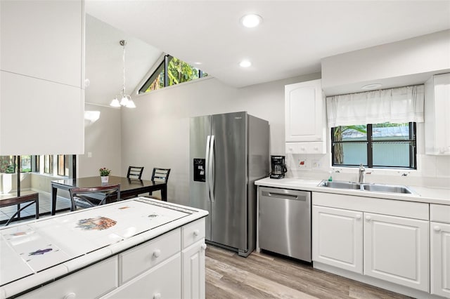 22004 Dupree Dr, Land O Lakes, FL 34639 - kitchen with stainless steel appliances, a sink, white cabinets, plenty of natural light, and recessed lighting