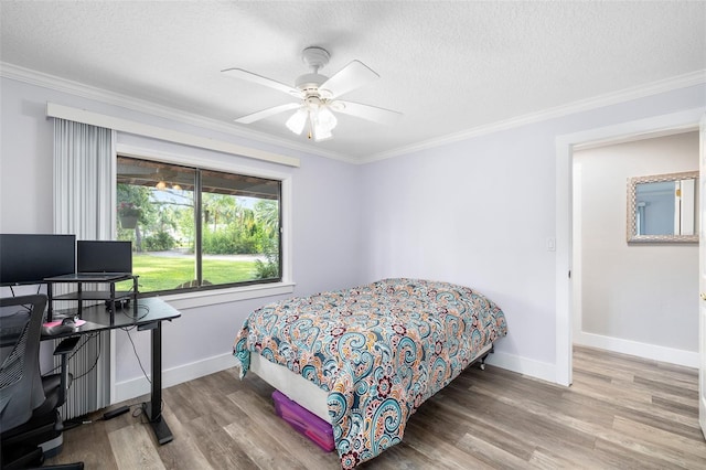 22004 Dupree Dr, Land O Lakes, FL 34639 - bedroom with a textured ceiling, ornamental molding, wood finished floors, an office area, and baseboards