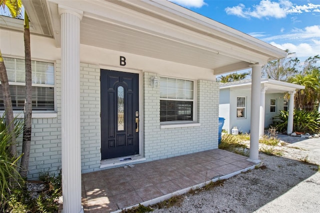 154 147th Ave E, Madeira Beach, FL 33708 - property entrance featuring brick siding and a porch