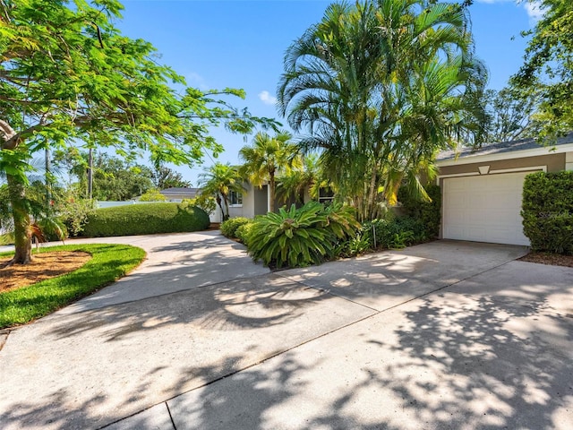 1701 38th St N, Saint Petersburg, FL 33713 - view of front of home featuring stucco siding, concrete driveway, and a garage