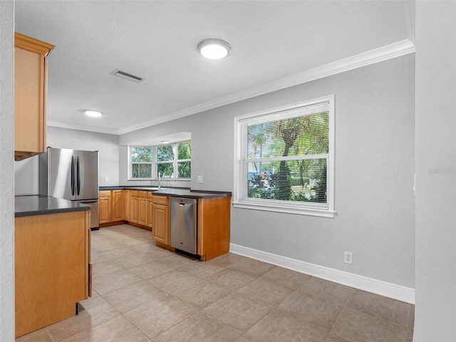 1701 38th St N, Saint Petersburg, FL 33713 - kitchen featuring stainless steel appliances, crown molding, dark countertops, baseboards, and light tile patterned floors