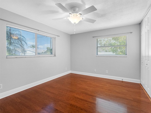 1701 38th St N, Saint Petersburg, FL 33713 - unfurnished room featuring wood finished floors, baseboards, ceiling fan, and a textured ceiling