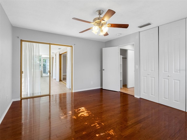 1701 38th St N, Saint Petersburg, FL 33713 - unfurnished bedroom with wood finished floors, baseboards, and ceiling fan