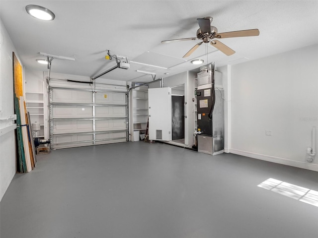 1701 38th St N, Saint Petersburg, FL 33713 - garage with ceiling fan, a garage door opener, and heating unit