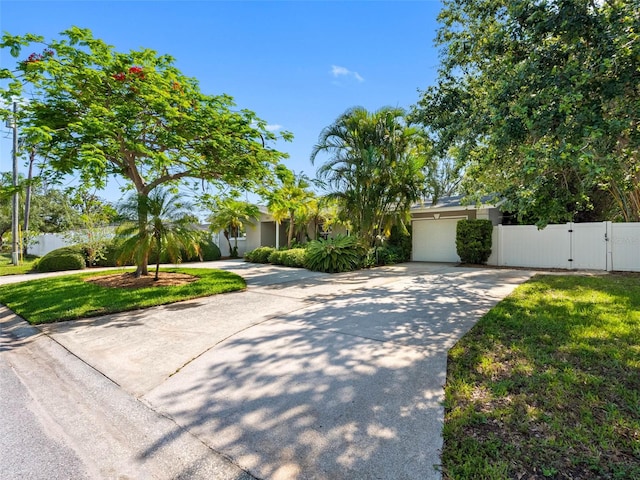 1701 38th St N, Saint Petersburg, FL 33713 - view of front facade featuring a gate, concrete driveway, a garage, and stucco siding