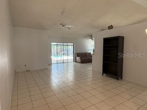 10811 Candlin Ct, Riverview, FL 33578 - empty room with ceiling fan, light tile patterned floors, and a textured ceiling