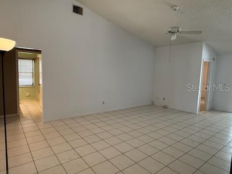 10811 Candlin Ct, Riverview, FL 33578 - additional living space featuring ceiling fan, light tile patterned floors, and vaulted ceiling