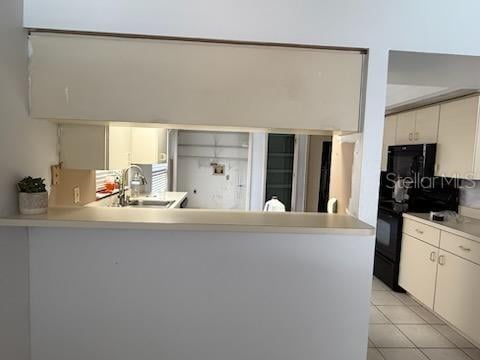 10811 Candlin Ct, Riverview, FL 33578 - kitchen featuring black appliances, a sink, light countertops, a peninsula, and light tile patterned floors