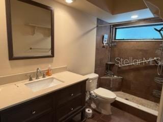 10811 Candlin Ct, Riverview, FL 33578 - bathroom featuring toilet, vanity, and a tile shower