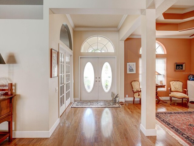 3910 Saywood Ct, Palm Harbor, FL 34685 - foyer featuring french doors, crown molding, wood finished floors, and baseboards