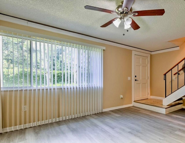 1877 Pine Cone Cir, Clearwater, FL 33760 - entryway with wood finished floors, a textured ceiling, plenty of natural light, ceiling fan, and stairs