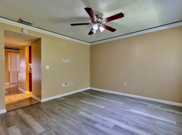 1877 Pine Cone Cir, Clearwater, FL 33760 - unfurnished room featuring wood finished floors, a textured ceiling, a ceiling fan, crown molding, and baseboards