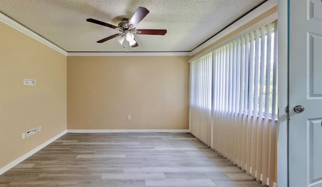 1877 Pine Cone Cir, Clearwater, FL 33760 - spare room featuring a ceiling fan, a textured ceiling, light wood finished floors, ornamental molding, and baseboards