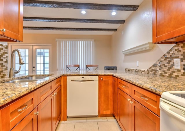1877 Pine Cone Cir, Clearwater, FL 33760 - kitchen featuring dishwasher, a sink, a peninsula, light stone counters, and tasteful backsplash