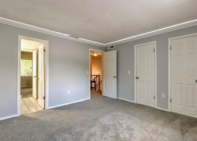 1877 Pine Cone Cir, Clearwater, FL 33760 - unfurnished bedroom with carpet, a textured ceiling, baseboards, and crown molding