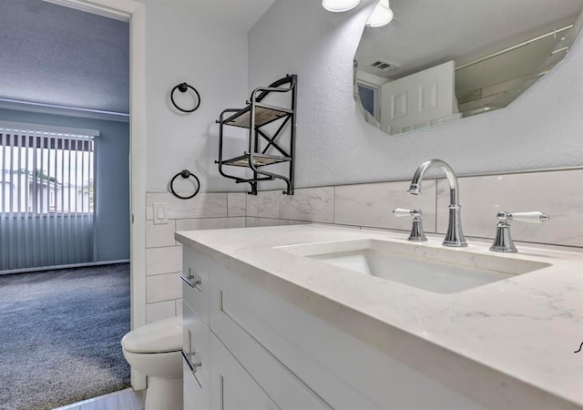 1877 Pine Cone Cir, Clearwater, FL 33760 - bathroom featuring toilet, tile walls, and vanity