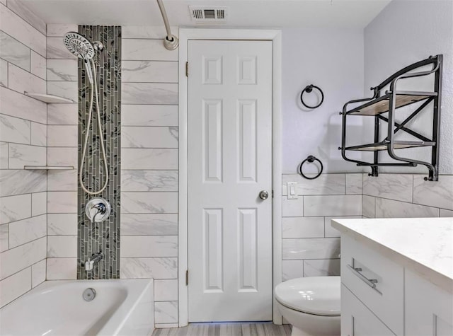 1877 Pine Cone Cir, Clearwater, FL 33760 - full bathroom with toilet, tile walls, vanity, washtub / shower combination, and a wainscoted wall