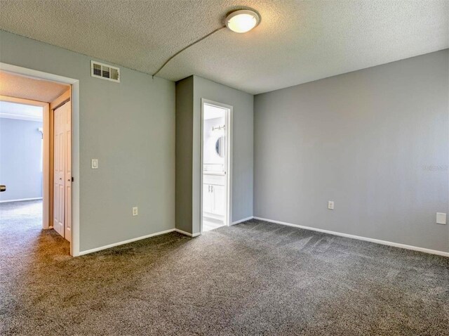 1877 Pine Cone Cir, Clearwater, FL 33760 - carpeted spare room with a textured ceiling and baseboards