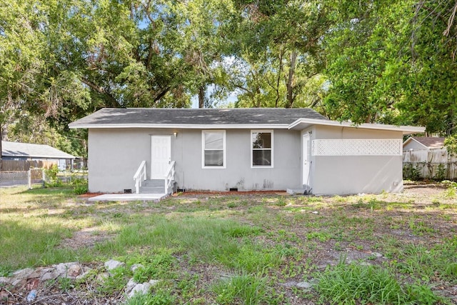 4804 N 18th St, Tampa, FL 33610 - rear view of house featuring entry steps and roof with shingles