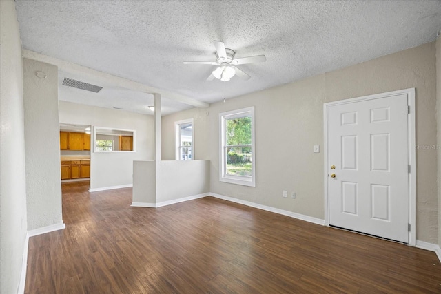 4804 N 18th St, Tampa, FL 33610 - unfurnished living room featuring ceiling fan, dark wood-style flooring, a textured ceiling, and baseboards