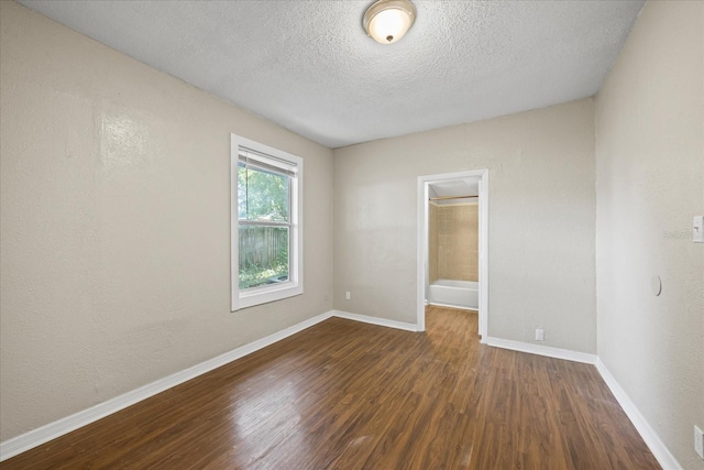 4804 N 18th St, Tampa, FL 33610 - spare room featuring wood finished floors, a textured ceiling, and baseboards