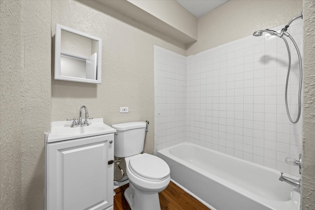 4804 N 18th St, Tampa, FL 33610 - full bath with wood finished floors, toilet, vanity, a textured wall, and bathing tub / shower combination