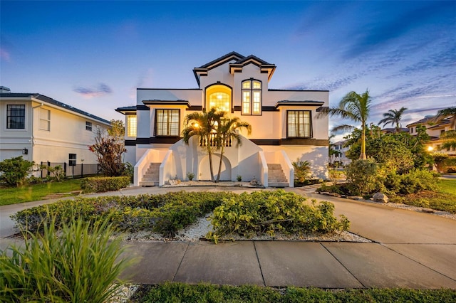 6024 Kipps Colony Dr E, Gulfport, FL 33707 - mediterranean / spanish-style home with stairs, stucco siding, and french doors
