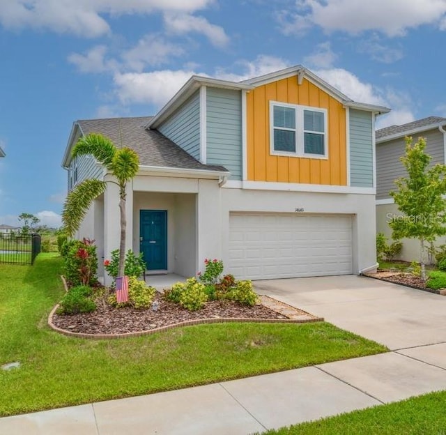 14643 Brumby Ridge Ave, Lithia, FL 33547 - view of front of property featuring board and batten siding, an attached garage, driveway, and stucco siding