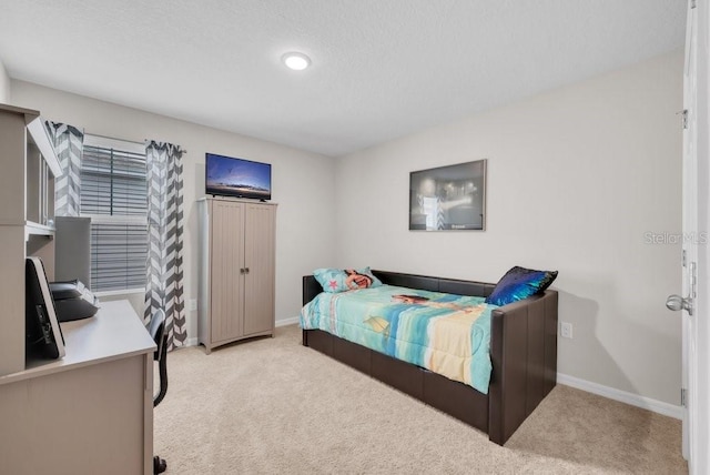 14643 Brumby Ridge Ave, Lithia, FL 33547 - bedroom with light colored carpet, baseboards, a desk, and a textured ceiling