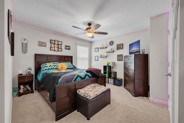 14643 Brumby Ridge Ave, Lithia, FL 33547 - bedroom with light colored carpet, a textured ceiling, a ceiling fan, and baseboards