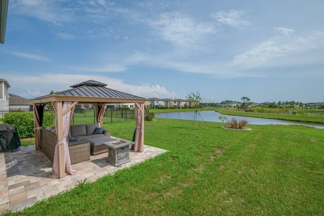 14643 Brumby Ridge Ave, Lithia, FL 33547 - view of grassy yard with a water view, an outdoor living space with a fire pit, a gazebo, and a patio area