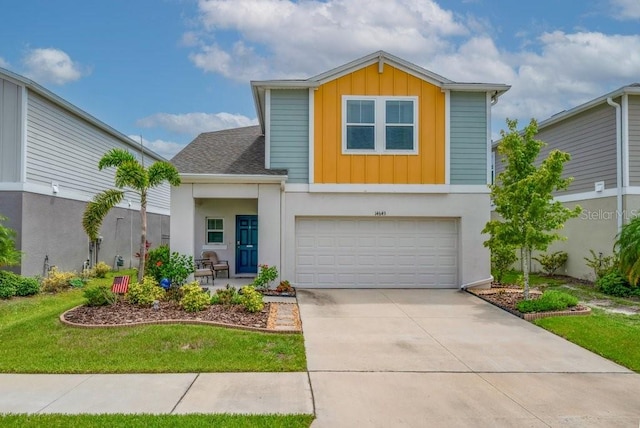 14643 Brumby Ridge Ave, Lithia, FL 33547 - view of front of home featuring board and batten siding, concrete driveway, an attached garage, stucco siding, and a front lawn