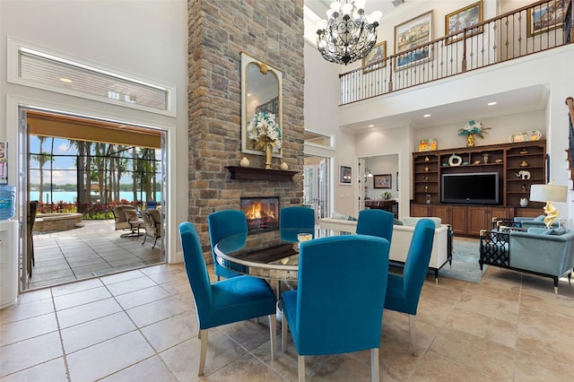 18258 Wayne Rd, Odessa, FL 33556 - dining room with a towering ceiling, a fireplace, a chandelier, light tile patterned floors, and crown molding