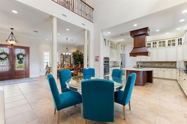 18258 Wayne Rd, Odessa, FL 33556 - dining space featuring ornate columns, recessed lighting, light tile patterned floors, french doors, and a chandelier